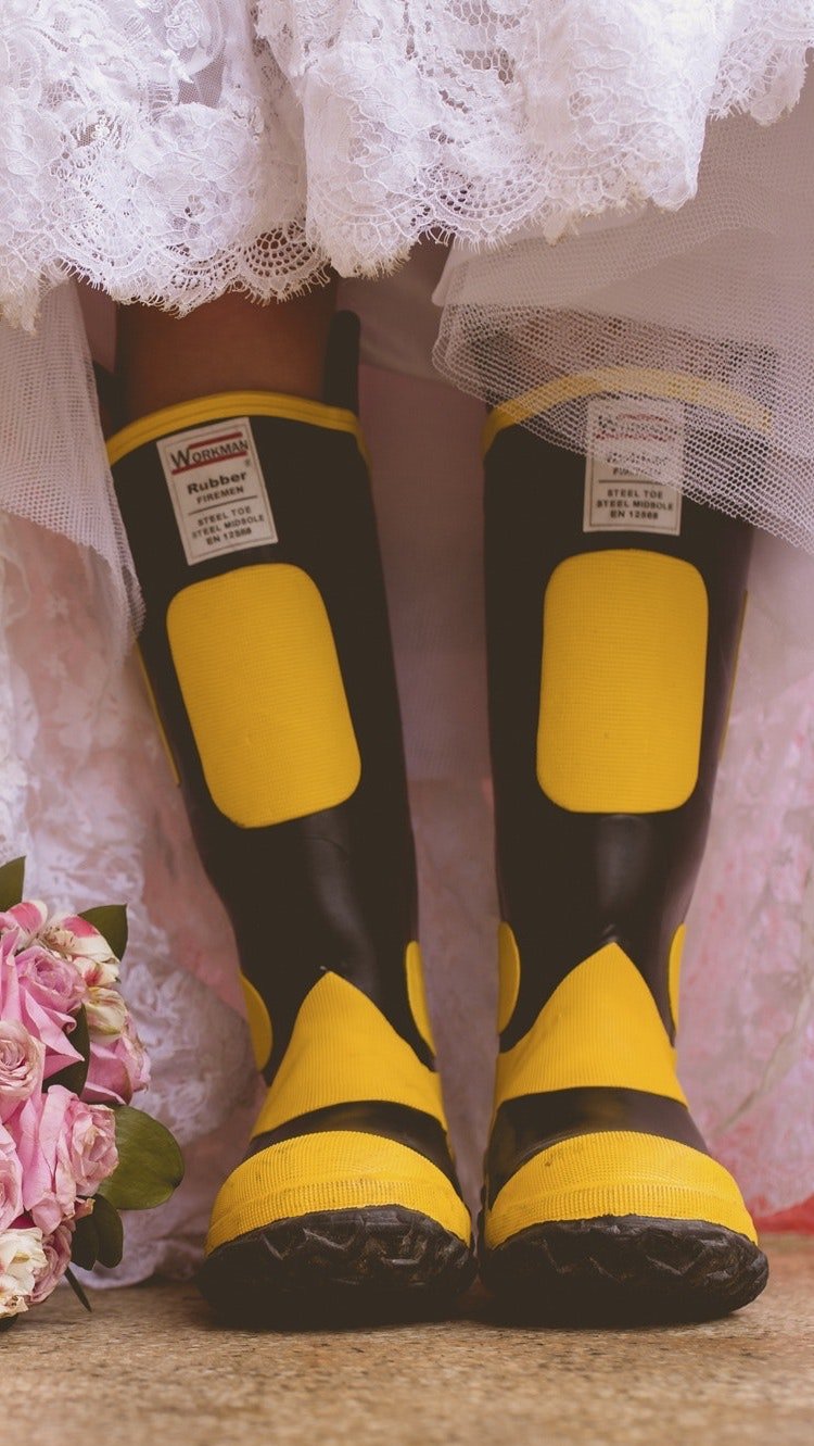 A bride's boots beside a bridal bouquet