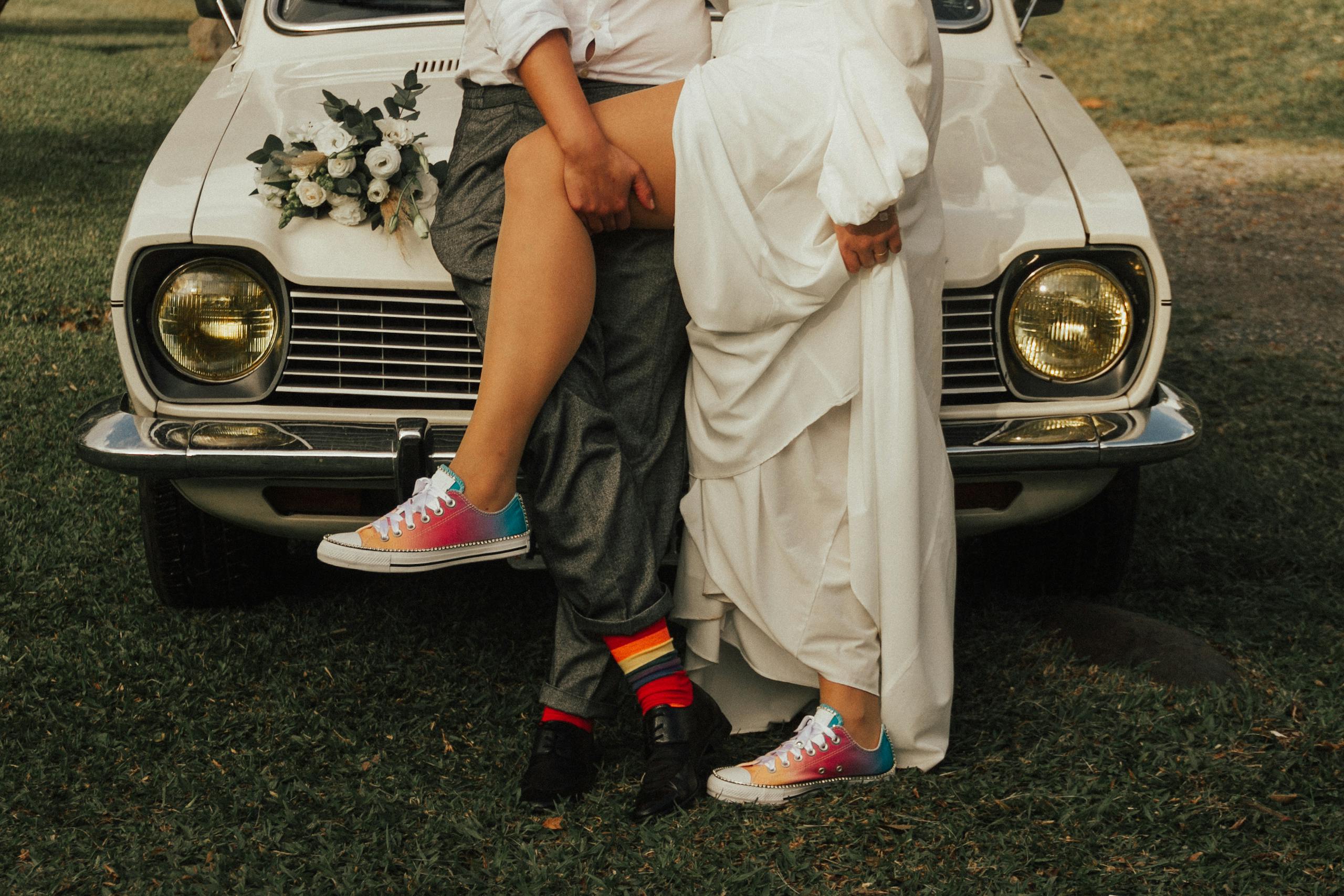 A bride and groom in playful sneakers sharing a quiet moment on their wedding day