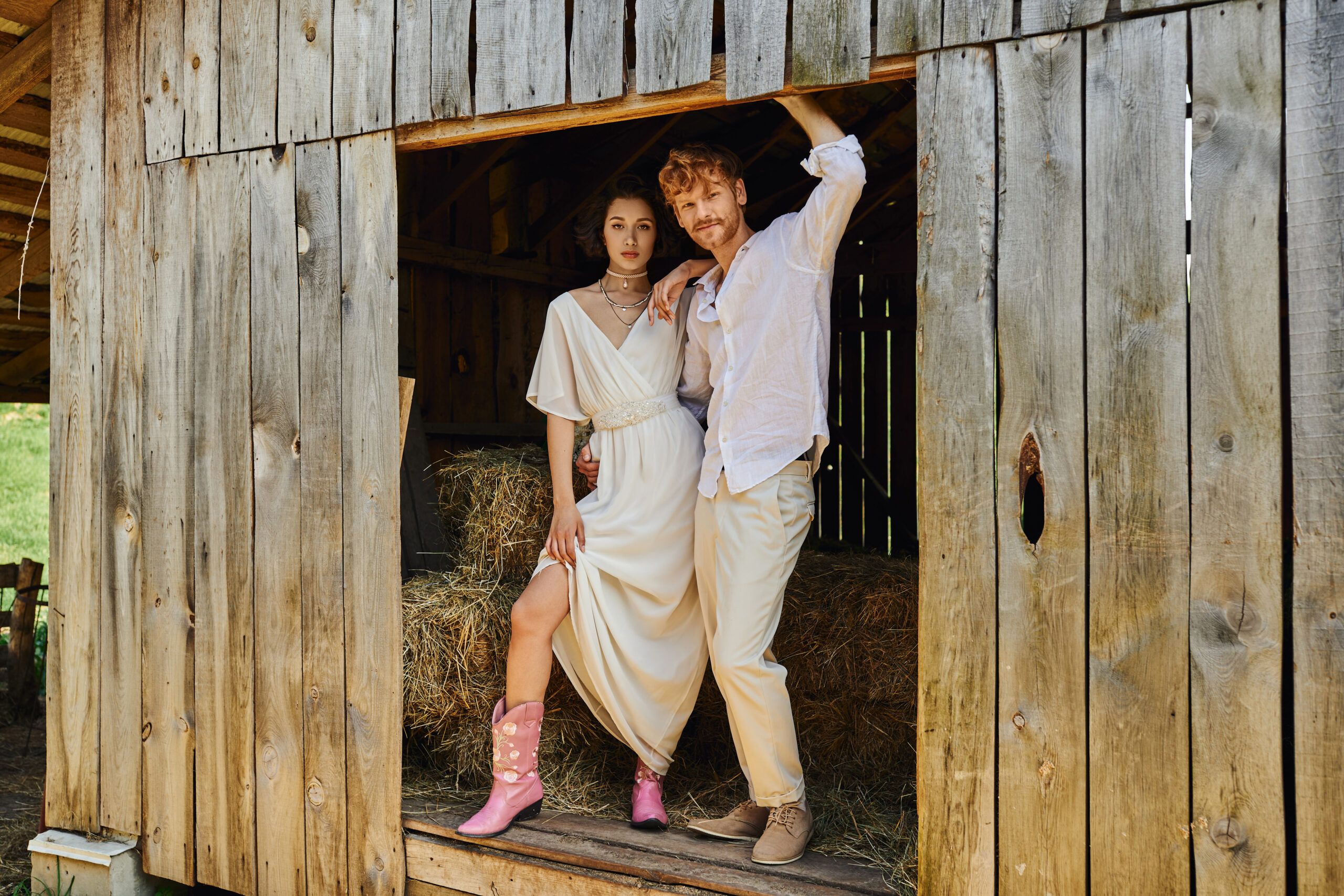Newlyweds outdoors, bride wearing cowboy boots